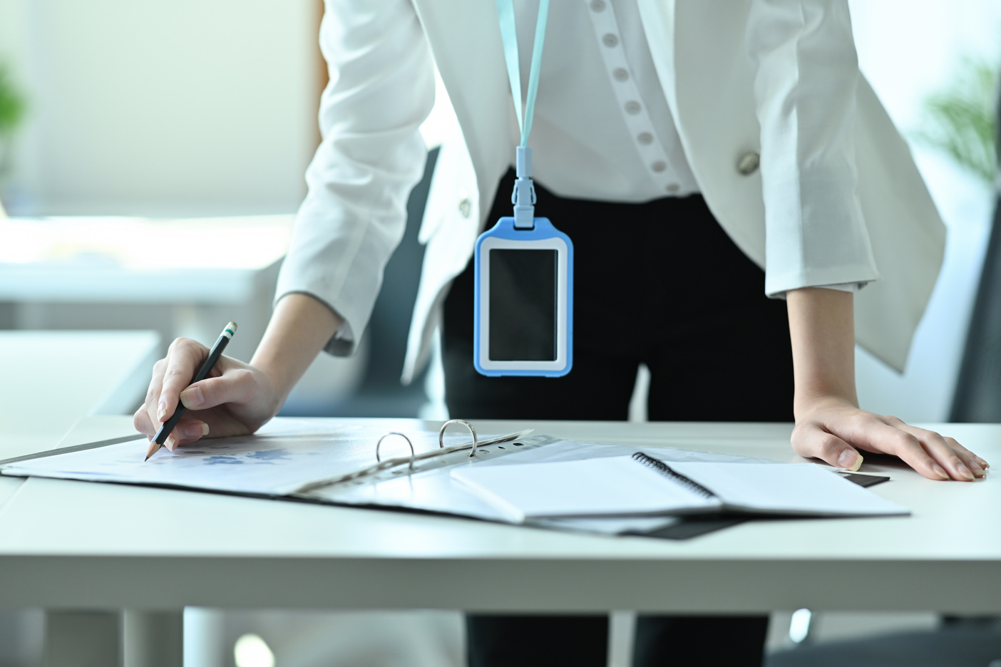 Cropped image of a young office woman standing and leaning o